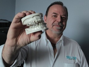 Patrick Strong, president and CEO of Strong Dental, displays a SUAD device, a dental sleep appliance used to treat snoring and all levels of obstructive sleep apnea. (JASON KRYK/The Windsor Star)