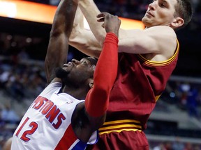 Cleveland's Tyler Zeller, right, grabs a rebound above Detroit's Will Bynum Wednesday, Feb. 12, 2014, in Auburn Hills, Mich. The Cavaliers won 93-89. (AP Photo/Duane Burleson)