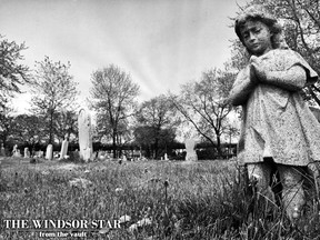 A statue looks over Assumption Cemetery on May 14, 1976. The original caption read that clues to our early history can be found throughout the cemetery. (BEV MACKENZIE/The Windsor Star)