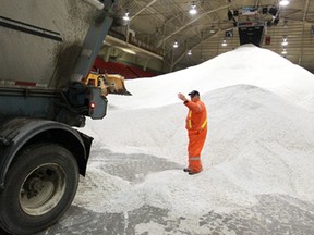 Dan Martinello, a public works employee for the City of Windsor, guides a bottom loader full of salt into the Windsor Arena where salt is being stockpiled, Friday, Feb. 14, 2014.  (DAX MELMER/The Windsor Star)