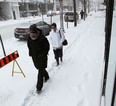 People make their way along snow-covered sidewalks on February 5, 2014. (TYLER BROWNBRIDGE/The Windsor Star)