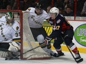 Windsor's Ben Johnson, right, is stopped by London goalie Jake Patterson, left, and Zach Bell Tuesday, Feb. 18, 2014, at the WFCU Centre in Windsor. (DAN JANISSE/The Windsor Star)