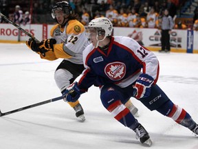 Windsor's Ben Johnson, right, and Sarnia's Jeff King battle during OHL action at the WFCU Centre, Sunday, Feb. 23, 2014.  Windsor defeated Sarnia 6-2. (DAX MELMER/The Windsor Star)