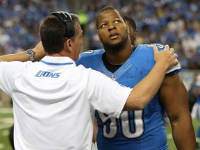 Former Detroit coach Jim Schwartz, left, talks with Ndamukong Suh during a game against Minnesota September 8, 2013 in Detroit. New defensive co-ordinator Teryl Austin said he's eager to work with Suh next season. (Leon Halip/Getty Images)