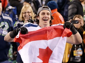 LaSalle's Luke Willson holds up a Canadian flag after his Seattle Seahawks defeated the Denver Broncos, 43-8, in the NFL Super Bowl XLVIII Feb. 2.  The local business community salutes the football star in this two-page spread. (AP Photo/Kathy Willens)