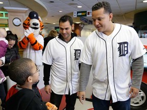 Detroit Tigers Miguel Cabrera, right, and pitcher Anibal Sanchez meet with fan Bejon Parks at Detroit Medical Center in Detroit  Jan. 23, 2014. The Tigers begin spring training workouts Friday in Lakeland, Fla. (AP Photo/Carlos Osorio)