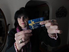 Amherstburg resident Tina Weber holds a RBC Visa prepaid card at her home on Feb. 6, 2014. She found out after using it that it had an expiry date. (JASON KRYK/The Windsor Star)