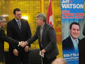 MP and President of the Treasury Board Tony Clement, left, shakes hands with  Centerline CEO Michael Beneteau as MP Jeff Watson looks on following a press conference at Centerline in Windsor,  Ontario on Feb 18, 2014. (JASON KRYK/The Windsor Star)