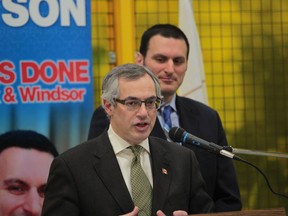 MP and president of the Treasury Board Tony Clement, left, speaks as MP Jeff Watson looks on at   Centerline in Windsor,  Ontario on Feb 18, 2014. (JASON KRYK/The Windsor Star)
