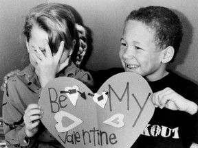 Robbin Walker, left, seems a bit overwhelmed by the amorous advances of classmate Michon Houston on Feb. 14, 1987, whose smile shows his heart is obviously in the right place.  (Nick Brancaccio/ Windsor Star)