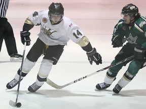 LaSalle's Nathan Savage, left, moves around St. Thomas' Chris Carreiro during junior B playoff action Wednesday, Feb. 26, 2014, at the Vollmer Centre in LaSalle. The Vipers won 3-0. (DAN JANISSE/The Windsor Star)