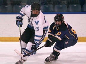 Villanova's James Brooks, left, is defended by St. Anne's Mike Elias during Game 1 of WECSSAA boy's hockey final between Villanova and St. Anne's at the Vollmer Complex, Tuesday, Feb. 25, 2014.  (DAX MELMER/The Windsor Star)