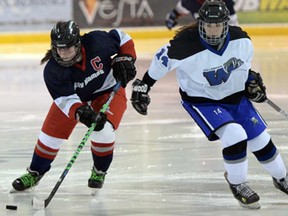 Lauren Lafler, left, of Holy Names, skates around Maddie DeFausses of Villanova in WECSSAA girls hockey playoff action Monday at the Vollmer Centre February 24, 2014. (NICK BRANCACCIO/The Windsor Star).