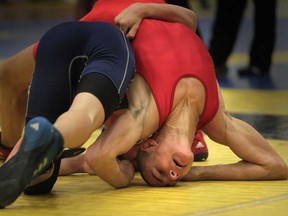 Tecumseh Vista's Scott Ostapovitch gets tangled up with Anthony Iancalla of Holy Names during the WECSSAA wrestling championships at Tecumseh Vista Academy on February 12, 2014 in Tecumseh. (JASON KRYK/The Windsor Star)