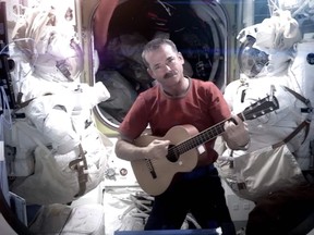 This image provided by NASA shows Canadian astronaut Chris Hadfield recording the first music video from space on May 12, 2013. The song was his cover version of David Bowie's Space Oddity.