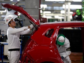 Employees work the assembly line in the new multibillion-dollar Honda car plant in Celaya, in the central Mexican state of Guanajuato, earlier this month. (Eduardo Verdugo / Associated Press)