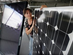 Green Sun co-owner Tanja Muske displays a photo voltaic panel, right, and a flat-plate solar heat collector, left, at their Kildare Road building in August 2009. (NICK BRANCACCIO / Windsor Star files)