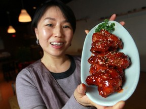 Roci Chung, manager at Emo Ne Korean Restaurant, is pictured with a plate of Y Y chicken. (DAX MELMER / The Windsor Star)