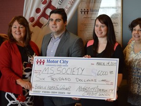 Becky Langlois, from left, marketing and communications manager of Motor City Credit Union, Jeff Galad, digital strategist of Postmedia, Shae Kavanaugh, student at law of Miller Canfield LLP and Jackie Putterman, special events coordinator of MS Society's Windsor branch hold a cheque for $6000 that the Beats n' Brews event raised in January. (Richard Riosa / The Windsor Star)