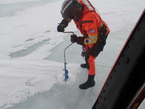 Petty Officer 3rd Class Scott Gendron of Coast Guard Air Station Detroit drills into frozen Lake Erie to gather ice depth measurements in support of the National Oceanic and Atmospheric Administration March 5, 2014. (Photo courtesy of USCG)