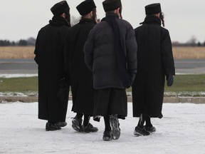 Youth from the Lev Tahor, a fundamentalist Jewish group, walk near St. Clair Road in Chatham, Ontario in November 2013. (JASON KRYK/Windsor Star files)