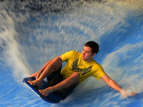 Michael Bauman, 17, catches a strong wave on Flowrider at Windsor's Adventure Bay and Aquatic and Training Centre Tuesday March 11, 2014. Record crowds have attended the popular downtown attraction during March Break. (NICK BRANCACCIO/The Windsor Star)