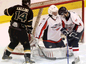 Windsor Junior Spitfires goalie Paolo Battisti, centre, makes a save against Mark Kallini of the London Jr. Knights. (Star file photo)