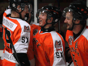 Essex forwards Scott Bromley, from left, Daniel Slipchuck, and Dylan Solecki celebrate a third-period goal against the Belle River Canadiens Tuesday in Essex. (DAX MELMER/The Windsor Star)