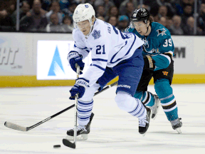 Toronto's James van Riemsdyk, right, is checked by San Jose's Logan Couture Tuesday in San Jose. (Photo by Thearon W. Henderson/Getty Images)