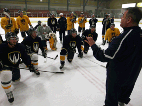 Lancers coach Kevin Hamlin, right, instructs his team during practice at South Windsor Arena, Wednesday. (DAX MELMER/The Windsor Star)