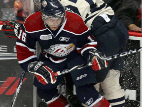 Saginaw's Terry Trafford, left, is checked by Windsor's Saverio Posa at the WFCU Centre in 2010. (TYLER BROWNBRIDGE/The Windsor Star)
