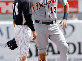 New York's Brian Roberts, left, talks with Detroit's Alex Avila Wednesday during the first inning of a spring training game in Tampa, (AP Photo/Kathy Willens)