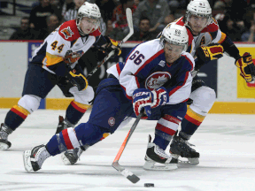 Windsor's Josh Ho-Sang, centre, is checked by Erie's Troy Donnay Thursday at the WFCU Centre. (DAX MELMER/The Windsor Star)