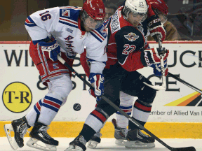 Kitchener's Brent Pedersen, left, is checked by Windsor's Sam Povorozniouk at the WFCU Centre. (DAN JANISSE/The Windsor Star)