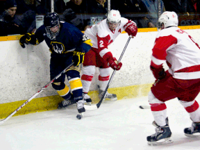 Windsor's Derek Lanoue. left, is checked by McGill's Jean-Philippe Mathieu, centre, while Ryan McKiernan looks for a loose puck Saturday during the Queen's Cup at South Windsor Arena. (JOEL BOYCE/The Windsor Star)