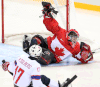 Kingsville’s Corbin Watson, right, makes a save against Norway’s Pallander Loyd-Remi Solberg during the bronze medal sledge hockey game at the 2014 Winter Paralympics in Sochi, Russia. (Leah Hennel/Calgary Herald)