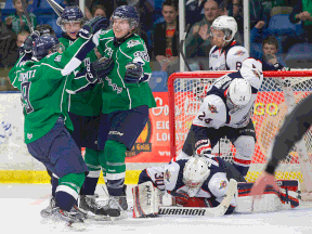 Plymouth's Zach Lorentz, from left, Ryan Hartman and Vincent Scognamiglio celebrate a goal in front of Spits goalie Dalen Kuchmey, Graeme Brown and Josh Ho-Sang Saturday in Plymouth. (RENA LAVERTY/Plymouth Whalers)