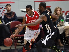 Windsor Express Stefan Bonneau drives against London Lightning Elvin Mims, right, in playoff basketball action from WFCU Centre Monday March 17, 2014. (NICK BRANCACCIO/The Windsor Star)