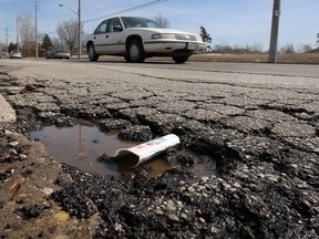 Both sides of Seminole Street near Ford Test Track Park have large pot holes, March 18, 2014.  (NICK BRANCACCIO/The Windsor Star)