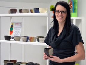 Walkerville Artist Co-op co-founder Dayna Wagner stands with a collection of handcrafted bowls which will be filled with soup and used in the Empty Bowls Project event hosted by the co-op March 22, 2014 (Richard Riosa/Special to The Star)