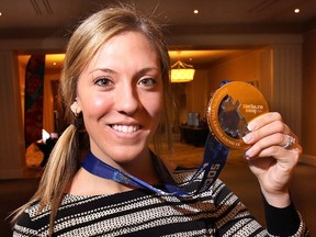 Meghan Agosta-Marciano displays her Olympic Gold medal, Tuesday, March 4, 2014, during a function at Caesars Windsor in Windsor, Ont. Agosta-Marciano was a guest speaker at the Domino's Canada national convention. (DAN JANISSE/The Windsor Star)