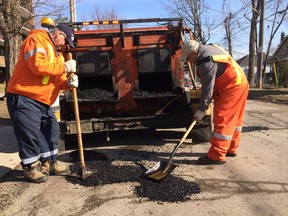 Long-time City of Windsor workers Luis Alvarez and Mario Tavoleri say the potholes this season are the worst they've ever seen. (TwitPic: Jason Kryk/The Windsor Star)