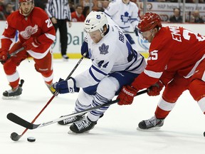 Detroit Red Wings center Cory Emmerton (25) defends Toronto Maple Leafs defenseman Morgan Rielly (44) in the third period of an NHL hockey game in Detroit, Tuesday, March 18, 2014. (AP Photo/Paul Sancya)