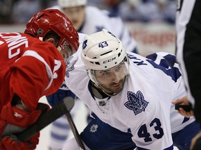 Cory Emmerton #25 of the Detroit Red Wings and Nazem Kadri #43 of the Toronto Maple Leafs face off during the second period of the game at Joe Louis Arena on March 18, 2014 in Detroit, Michigan. The Red Wings defeated the Maple Leafs 3-2. (Photo by Leon Halip/Getty Images)