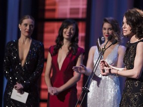Tatiana Maslany (right) accepts the award for Best Performance by an Actress in a Continuing Leading Dramatic Role for 'Orphan Black' at the Canadian Screen Awards in Toronto on Sunday March 9, 2014. THE CANADIAN PRESS/Chris Young