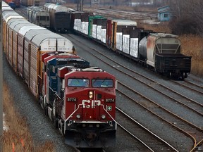 CP freight train hauling dozens of automobile rail cars, heads east along tracks at North Service Road crossing Thursday March 20, 2014. (NICK BRANCACCIO/The Windsor Star)