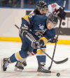 University of Windsor Lancers forward Mike Christou, front, and Acadia University Axemen forward Brett Thompson battle for the puck at the CIS University Cup in Saskatoon. (THE CANADIAN PRESS/Liam Richards)