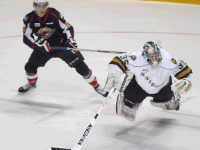 Windsor's Ben Johnson, left, and London goalie Jake Patterson collide at the WFCU Centre. (DAN JANISSE/The Windsor Star)