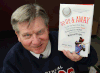 Photographer Russ Hansen poses with a book on the Montreal Expos called Up, Up & Away which features his work. (DAN JANISSE/The Windsor Star)