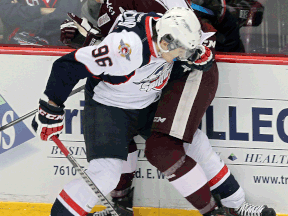 Windsor's Cristiano DiGiacinto, left, collides with Peterborough's Clark Seymour at the WFCU Centre. (TYLER BROWNBRIDGE/The Windsor Star)